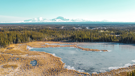 Picture of the many scenes Alaska has to offer as the state begins to put on its winter coat. Lakes begin to freezeand frost forms on the foliage as the temperature begins to drop.  The transformation is a stunning view from the vantage point of a drone. Wrangle Mountains make a great backdrop to this scene.