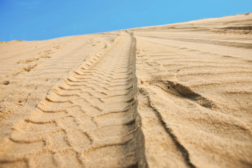 Car tracks on sand