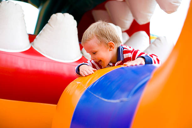 istock Four-year-old kid playing on a trampoline outdoor 175116062