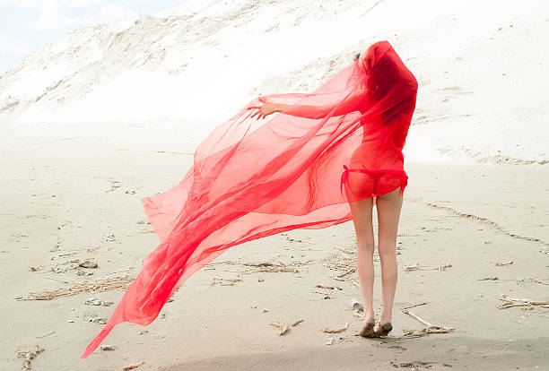 istock Attractive naked girl on sand. Back view 175116068