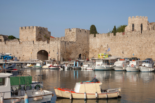 fishing boats and the medieval wall in Rhodos town, Greece