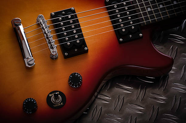 istock Cherry Red Electric Guitar on Studded Metal Surface 175116539