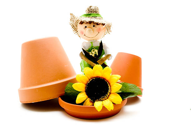 istock Flowerpot with straw doll and flowers 175116613