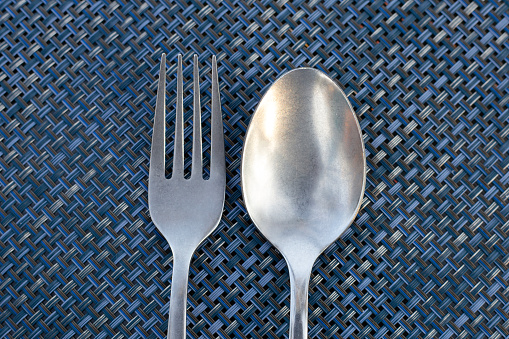 Spoon and fork on place mat