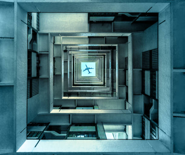 Sitting on the ground floor of the patio of a residential building looking up at a plane in the sky.