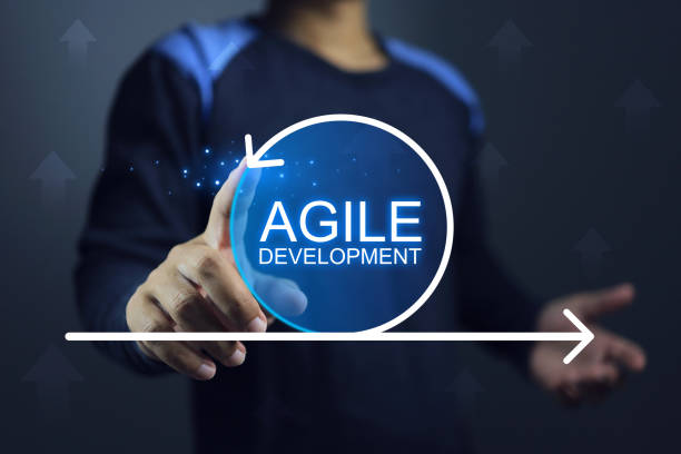 Development engineer Agile engineer or software developer hand pointing on agile development cycle on black background. Agile development concept. scrum stock pictures, royalty-free photos & images