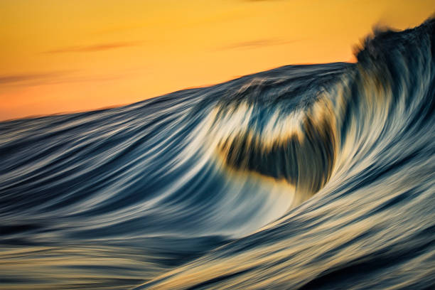 istock Motion blur of smooth wave forming in golden light 1751227977