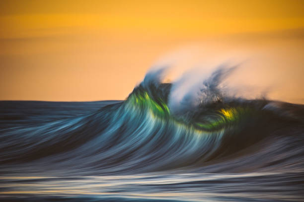 istock Motion blur of smooth wave forming in golden light 1751229567