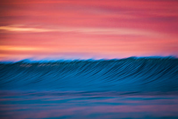 istock Motion blur of smooth wave forming against a crimson sky 1751231093