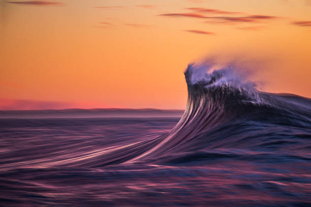 istock Motion blur of smooth wave forming in golden light 1751232251