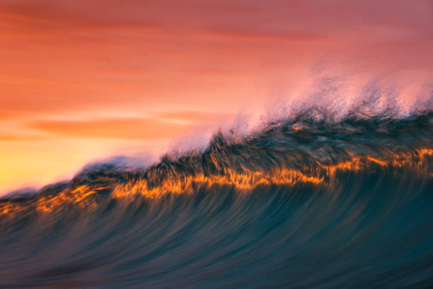 istock Motion blur of abstract wave forming in orange and gold light at sunset 1751232268