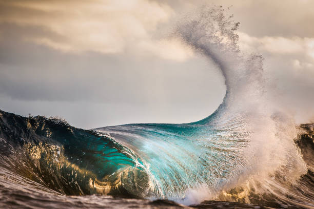 istock Ocean energy colliding and exploding into golden light forming a fan of water texture 1751233861
