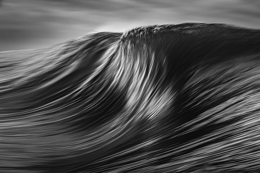 Monochrome motion blur of abstract wave forming.