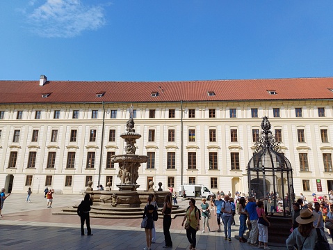 Prague, Czech Republic - June 9, 2023: Tourists enjoy Gothic architecture on the courtyard of Prague Castle, Prague city.
