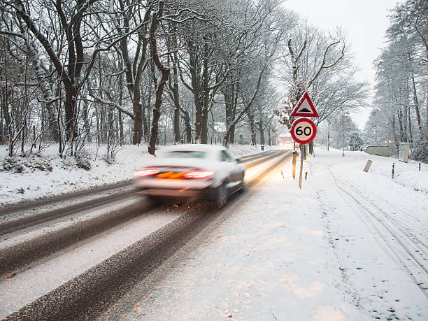 istock fast moving car brakes in a snow storm 175125840