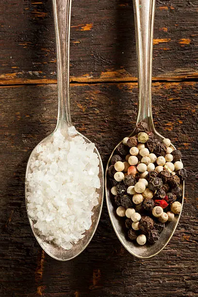 Raw Organic Sea Salt and Pepper against a background
