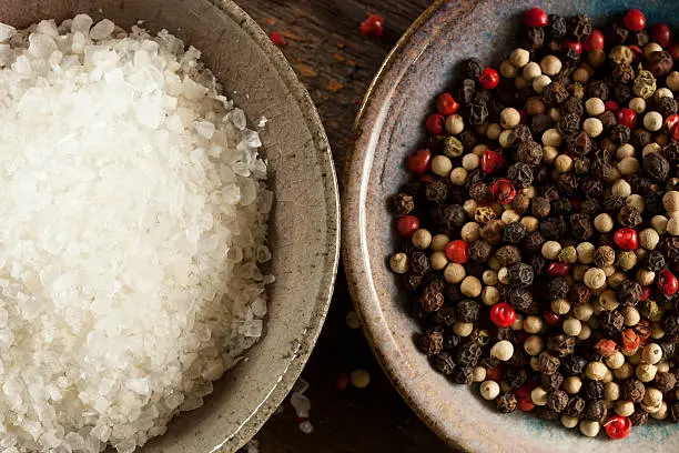 Raw Organic Sea Salt and Pepper against a background