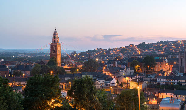 St Anne's church in Shandon, Cork Cork, Ireland - July 19, 2013: St. Anne's in Shandon and the City of Cork photographed against a beautiful sunset at dusk. irish culture photos stock pictures, royalty-free photos & images