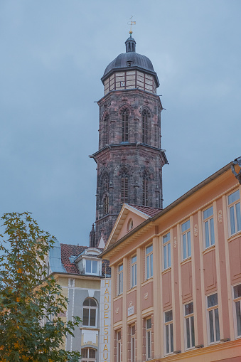 Göttingen, Germany, 16. October 2023 - St. Jacob protestant Church tower in the historic centre of Göttingen Lower Saxony Germany with Facades of the main street Weender Street.