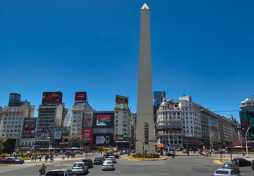 buenos aires, Argentina - 04 November 2022: many cars are driving on an urban inner city avenue with buildings around and obelisk
