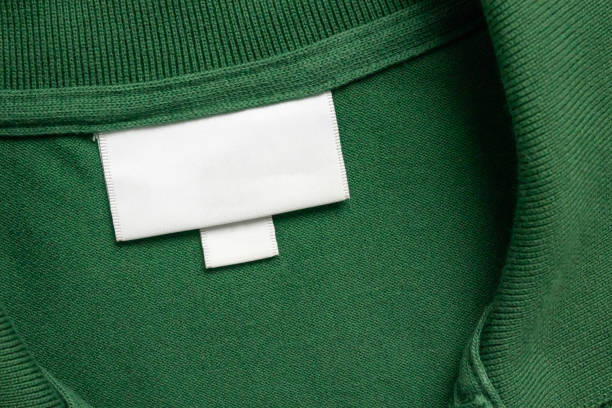 istock Blank white laundry care clothes label on green shirt fabric texture background 1751326179