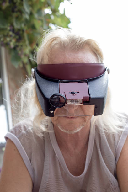 istock A blond Caucasian man wearing a head loupe at work. A tool for small delicate work with objects and electronics 1751329058