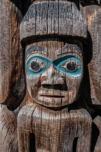 a detail from a Coast Salish totem pole outside the entrance to the Horseshoe Bay Ferry Terminal, Horseshoe Bay, BC, Canada