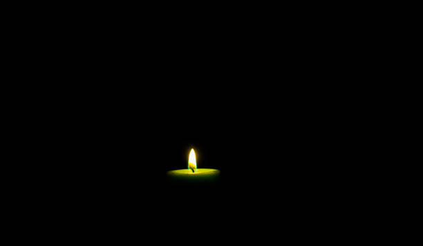 istock a single candle with its lit flame burning on a black background 1751381670