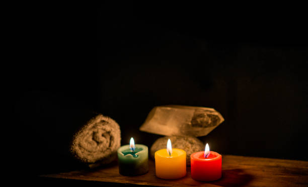 istock lit candles with stones and wood on a dark background 1751383835