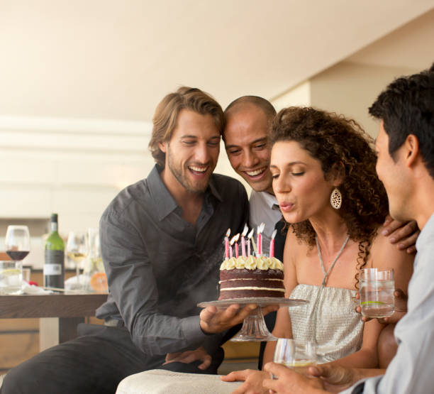 istock Woman blowing out birthday candles 175138822