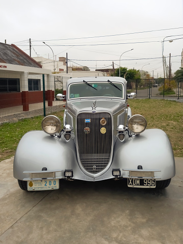 Lanús, Argentina - Sept 23, 2023: Old silver gray 1933 Ford Model 40 V8 Victoria Tudor sedan hot rod at a classic car show.