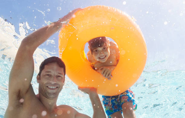 istock Father and son playing in swimming pool 175139119