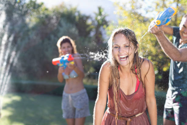 istock Friends playing with water guns in backyard 175139120