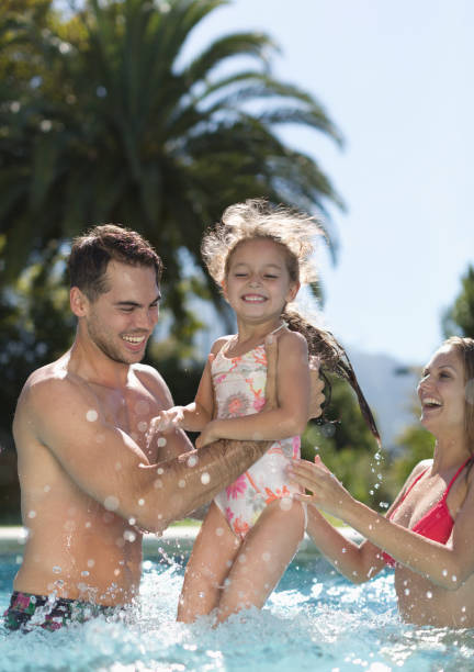 istock Family playing in swimming pool 175139144