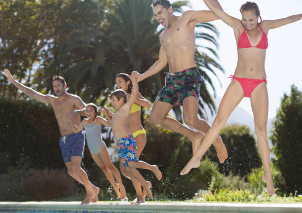istock Family jumping into swimming pool 175139186