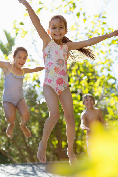 istock Children jumping on trampoline outdoors 175139197