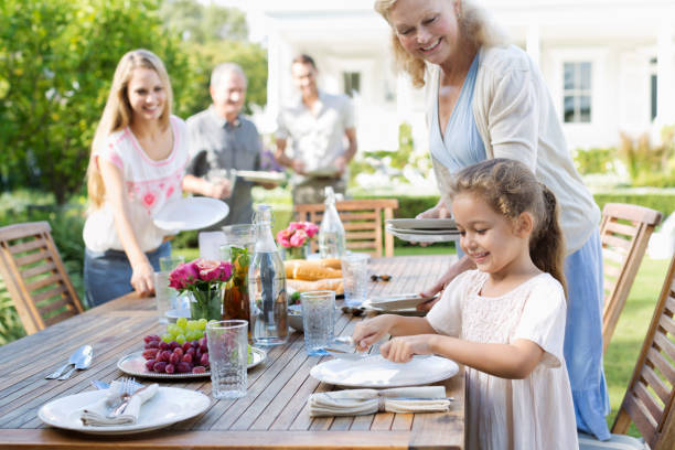 family setting table outdoors - senior adult old young adult couple 뉴스 사진 이미지