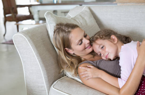 istock Mother and daughter relaxing on sofa 175139276