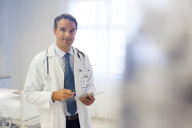 istock Doctor reading clipboard in hospital room 175139292