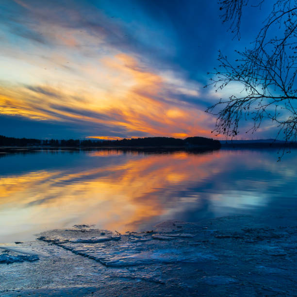 Colorful sunset over half frozen lake