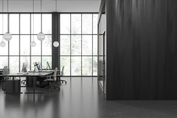 istock Gray and wooden open space office with blank wall 1751393027