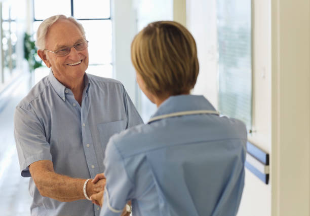istock Older patient and nurse shaking hands in hospital 175139319