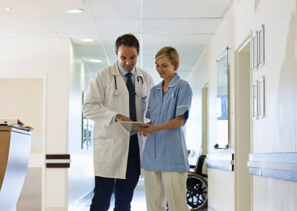 istock Doctor and nurse using tablet computer in hospital hallway 175139398