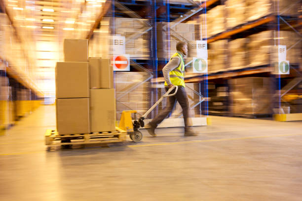 istock Blurred view of worker carting boxes in warehouse 175139595