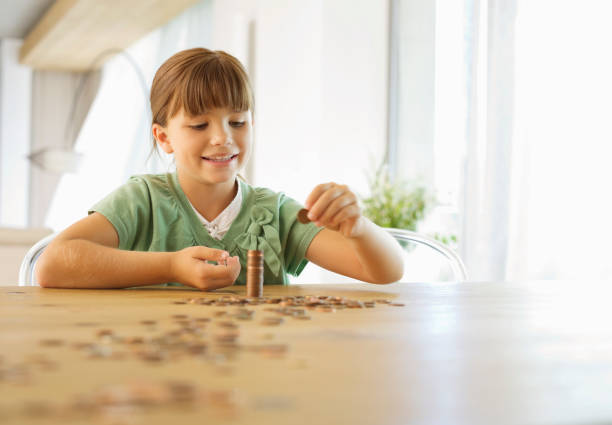 istock Girl stacking pennies on counter 175139831