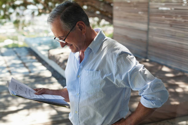 istock Businessman reading papers outdoors 175139874