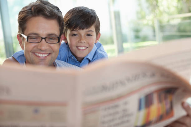 istock Father and son reading newspaper together 175139890