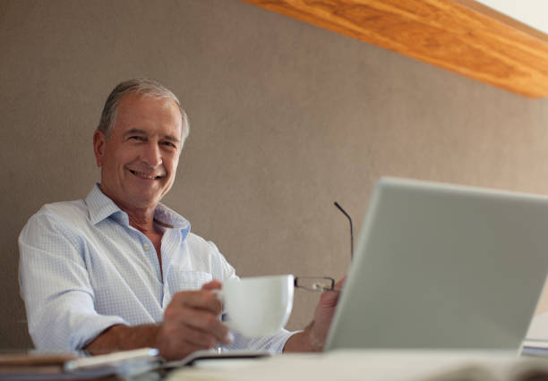 istock Older man having cup of coffee at desk 175139969