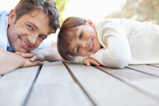 istock Father and daughter laying on porch 175139971