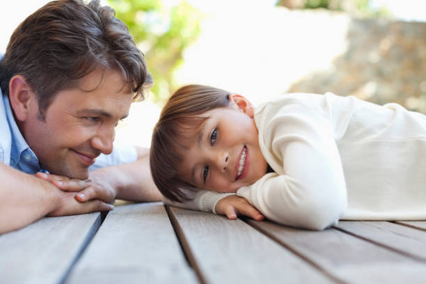 istock Father and daughter laying on porch 175139975